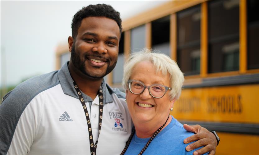Two employees smile